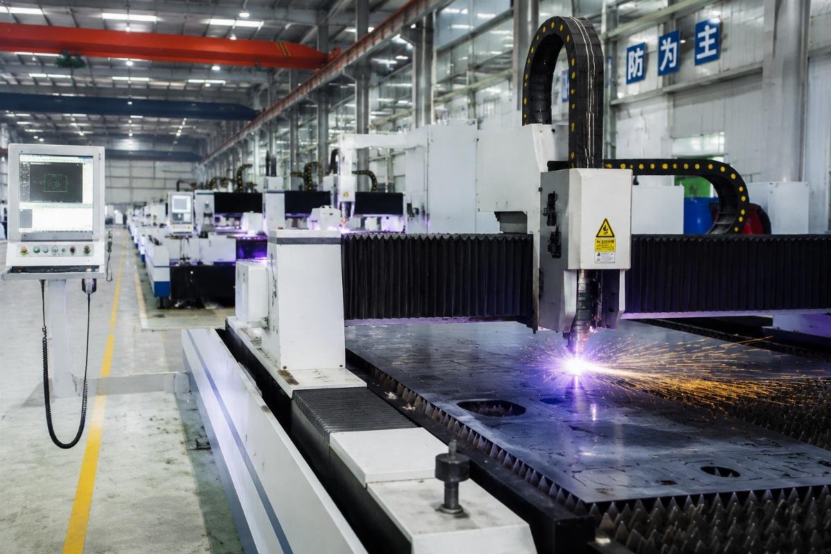 Production facility with multiple CNC systems operating Manufacturing floor with active CNC cutting machines